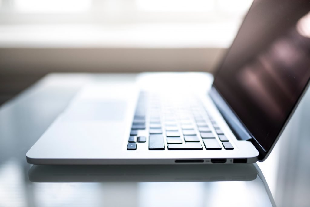 Apple Macbook on a table open with the keyboard facing the camera