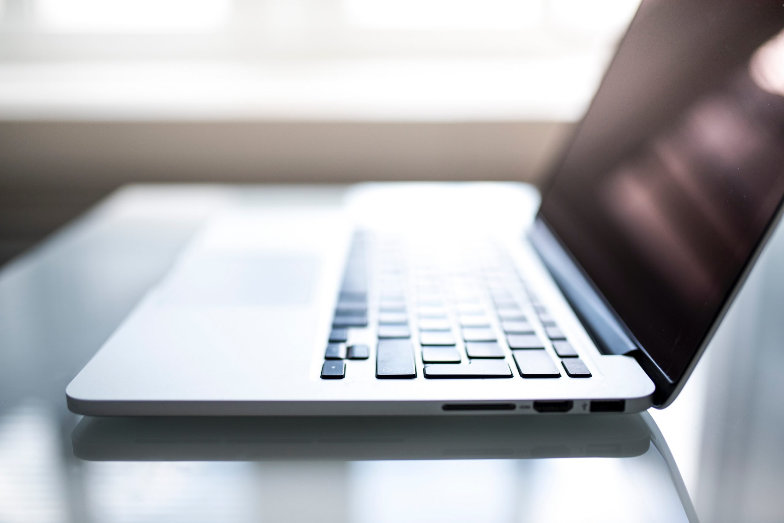 Apple Macbook on a table open with the keyboard facing the camera