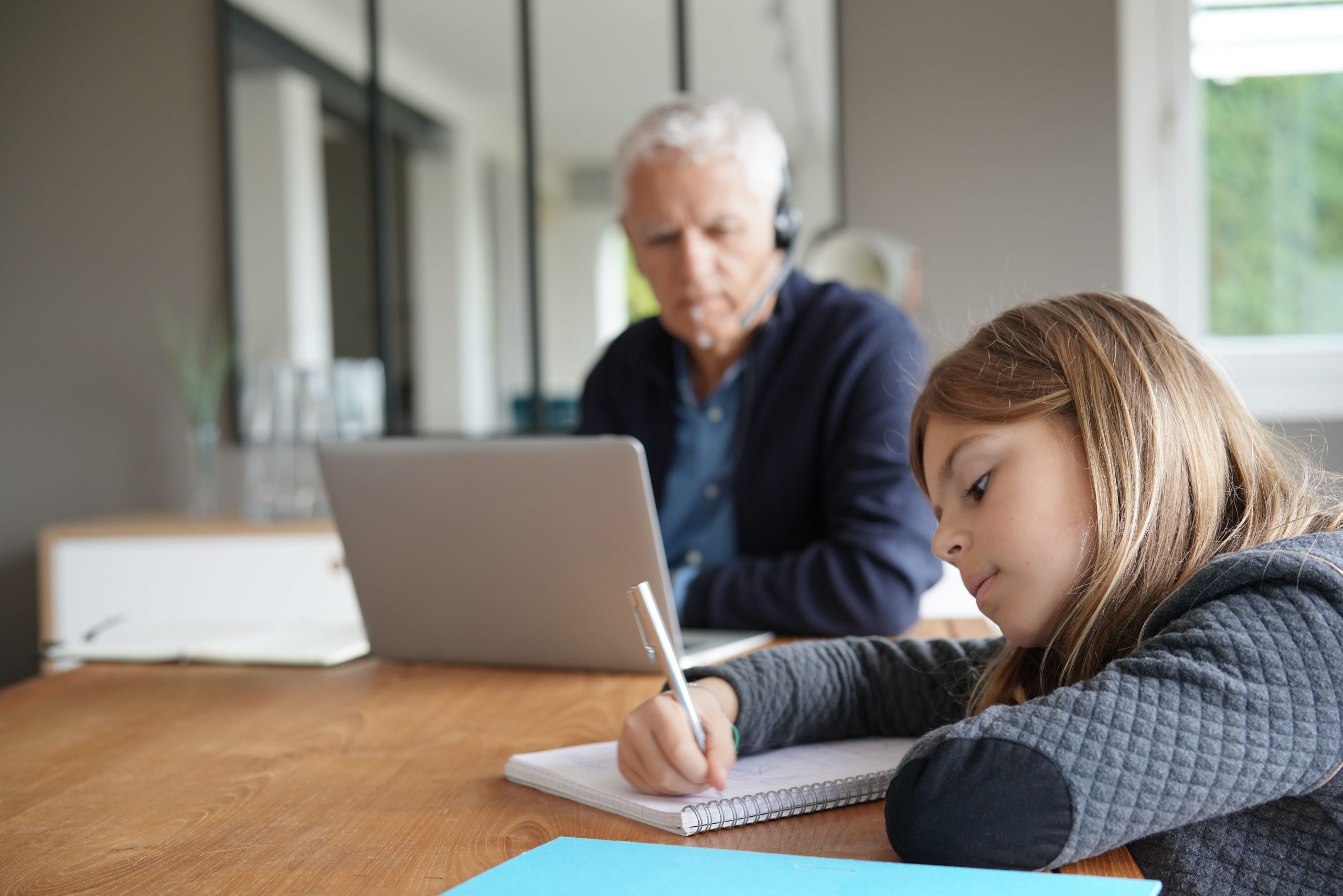 Man,Working,From,Home,And,Watching,Kid,Out,Of,School