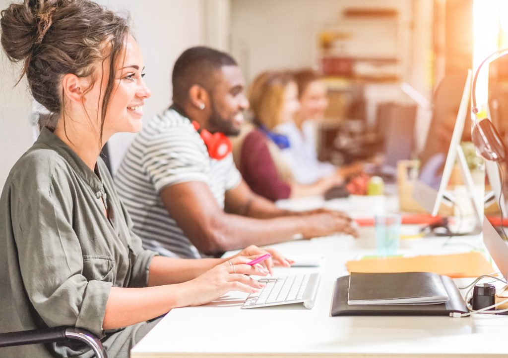 Young,Trendy,Teamwork,Using,Computer,In,Creative,Office,-,Business