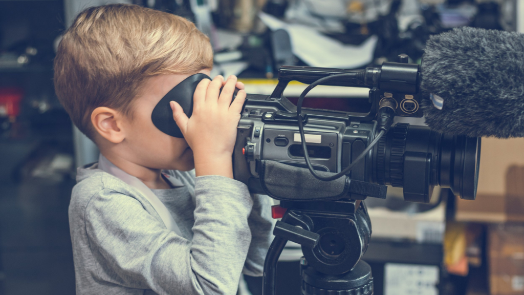 Young boy using a video camera