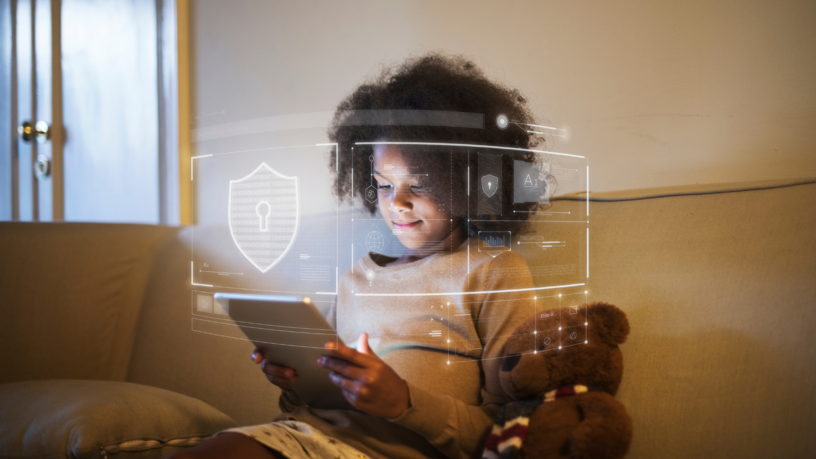 Young mixed race child using digital tablet with illustration of shield superimposed over the top.