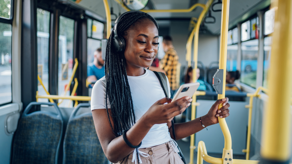 African american woman using smartphone while riding a bus