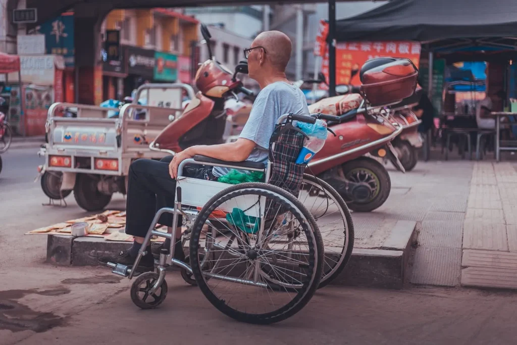 Man outside on the street in a wheelchair