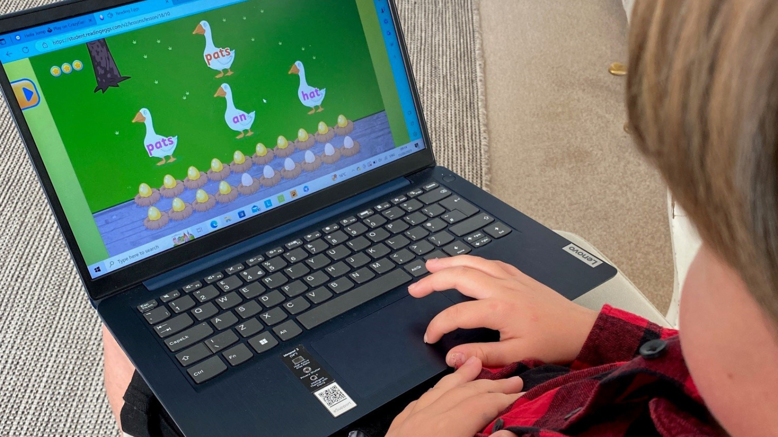 Young boy using laptop to do homework and language learning