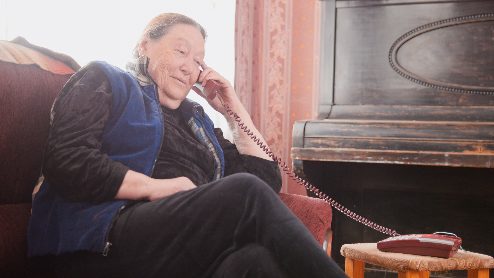 Old Woman pensioner speak landline telephone, wide angle