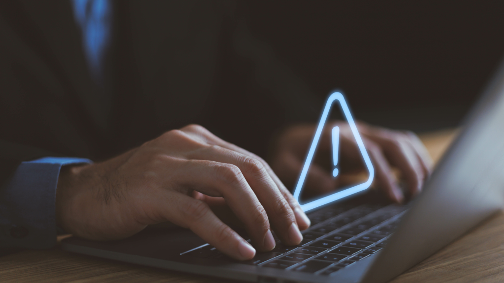 Businessman using computer laptop with triangle caution warning sign, available for notification error and maintenance concept, warning risk on device, failure security system online technology