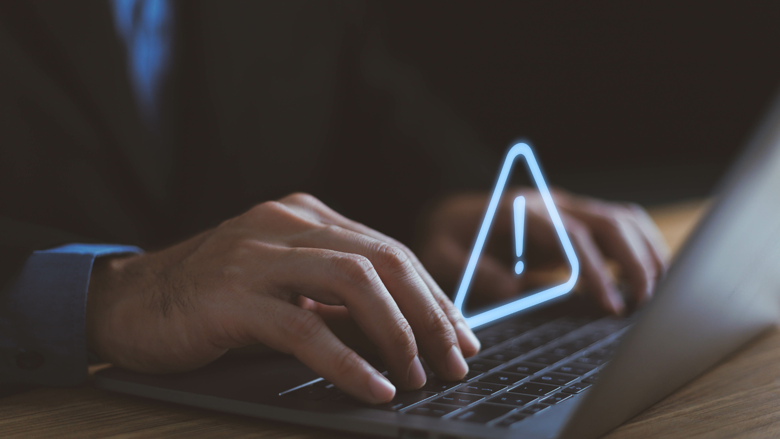 Businessman using computer laptop with triangle caution warning sign, available for notification error and maintenance concept, warning risk on device, failure security system online technology