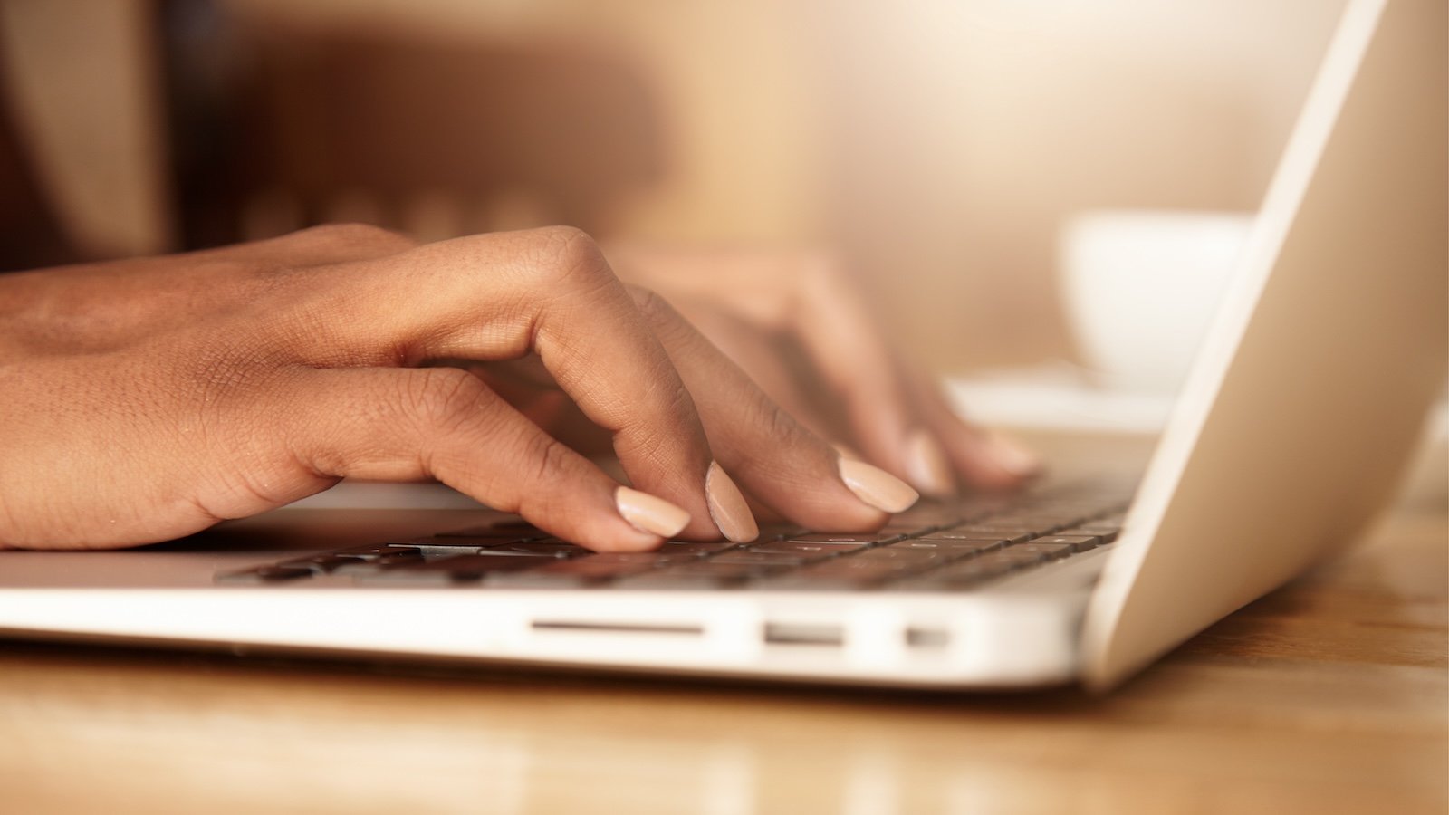 Woman's hands typing on laptop.