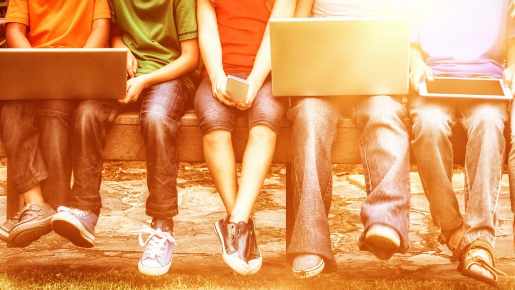 Youth together using laptops.