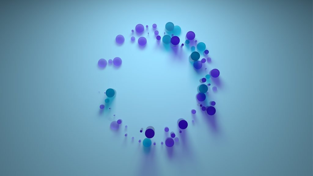 A circle of purple and green dots n top of a light blue background.