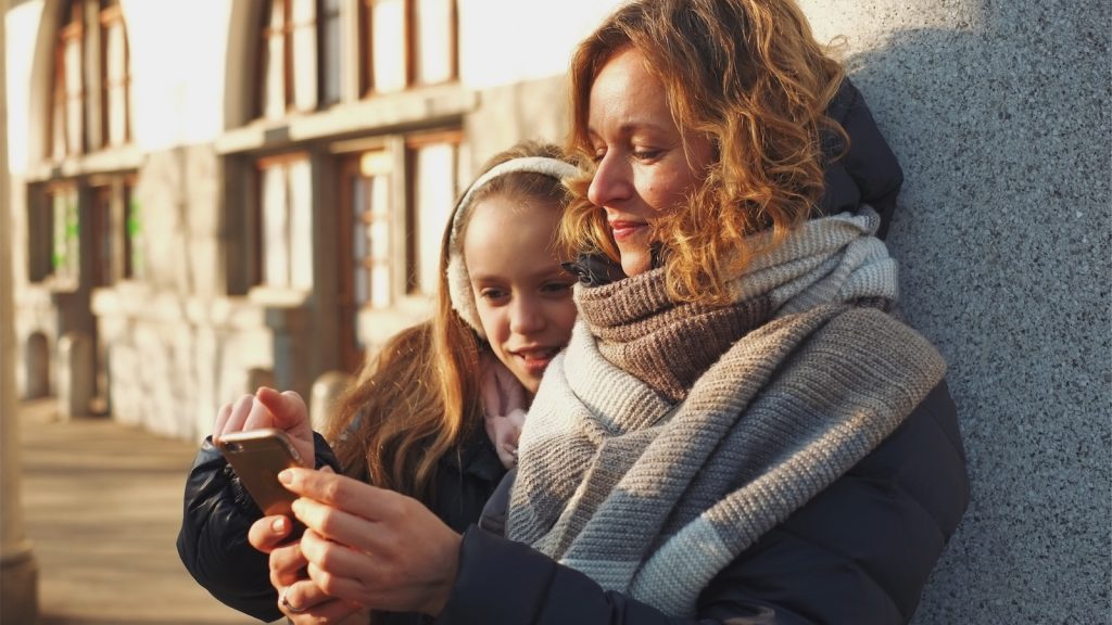 Mother and daughter using a mobile phone.